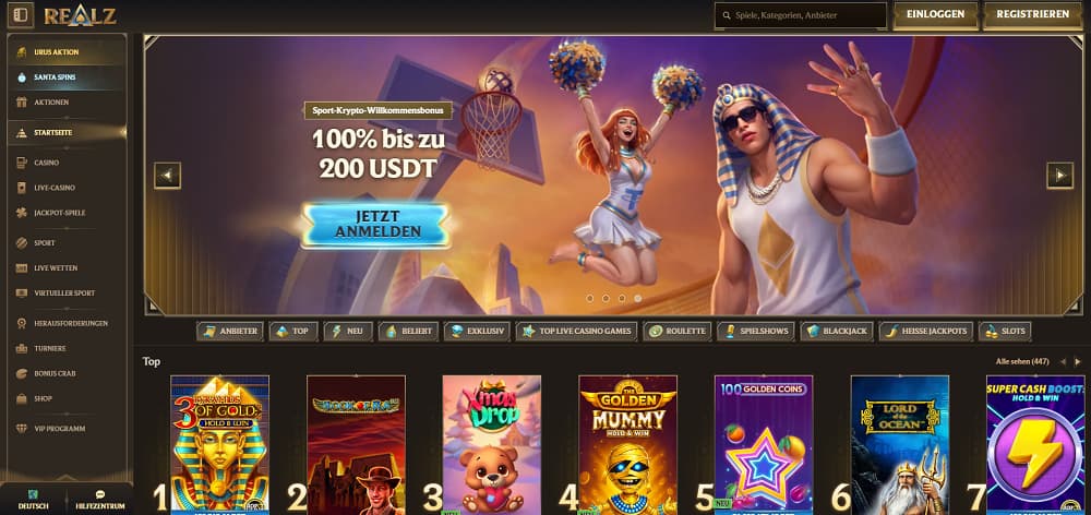 Realz Casino-Startseite mit einem lebhaften Banner mit Cheerleader und ägyptisch gekleidetem Charakter, der einen 100 % Sport-Krypto-Bonus bis zu 200 USDT bewirbt. Die dunkle Oberfläche bietet Navigation für Casino, Live-Spiele, Sportwetten, Jackpots und Top-Slots wie Golden Mummy – Hold & Win und Lucky Joker 100.